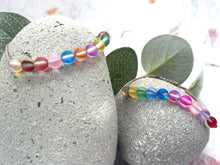 Load image into Gallery viewer, nicorn Mystic Aura Quartz 10 Breaths Bracelet – a rainbow-hued, handcrafted breathing bracelet designed to support your daily mindfulness, meditation, and anxiety relief rituals.
Made with 10 luminous frosted aura quartz beads that shimmer with soft, magical color shifts, this bracelet brings a touch of whimsy and healing energy to your breathwork.