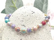 Load image into Gallery viewer, lilac and blue sea sediment stones on a pink cord with tiny gold coloured glass beads to finish it off