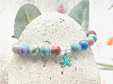 Load image into Gallery viewer, The ten lilac and blue 8mm sea sediment stones with a central turquoise starfish charm making up your 10 breaths bracelet