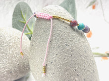 Load image into Gallery viewer, lilac and blue sea sediment stones on a pink cord with tiny gold coloured glass beads to finish it off
