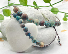 Load image into Gallery viewer, Blie Green Calsilica Anxiety Calming Bracelets.  6mm and 8mm stones on a cotton cord the help alleviate anxiety and stress
